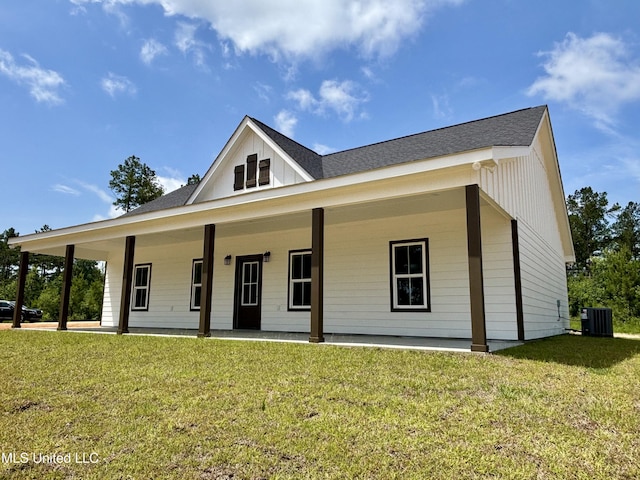 2719 Bouie Rd, Poplarville, MS 39470 - modern inspired farmhouse featuring a front lawn, roof with shingles, and board and batten siding