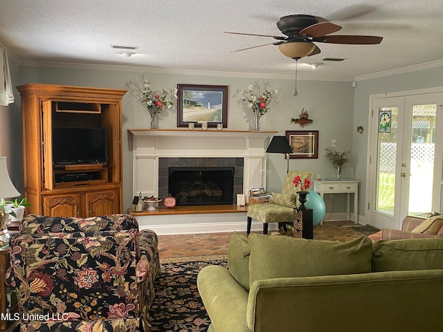 living room with a fireplace, ceiling fan, a textured ceiling, and french doors