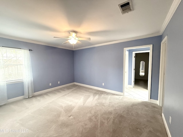 unfurnished bedroom with carpet floors, ornamental molding, and visible vents