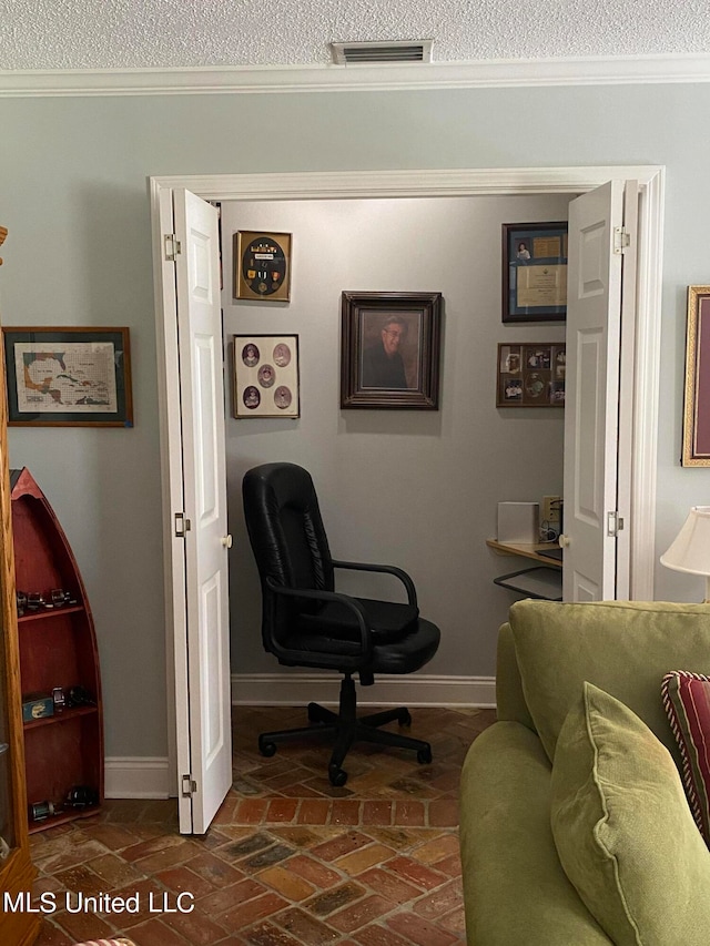 home office featuring a textured ceiling and crown molding