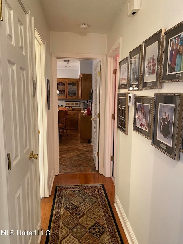 hallway with hardwood / wood-style floors