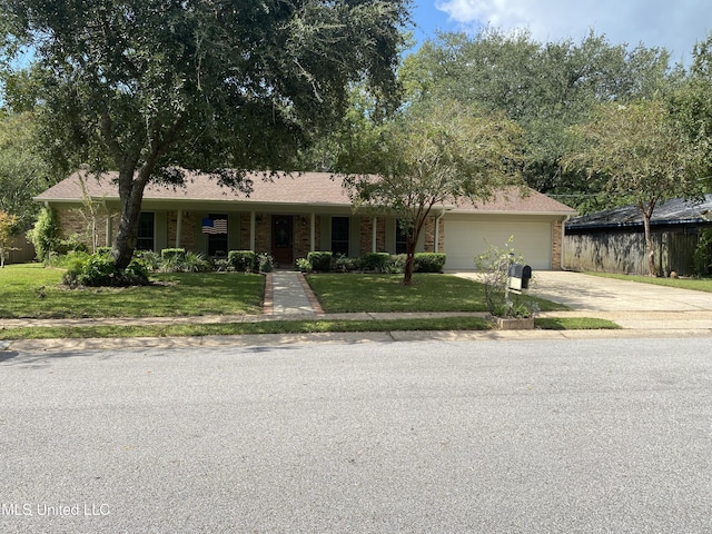 ranch-style house with brick siding, an attached garage, a front lawn, and concrete driveway