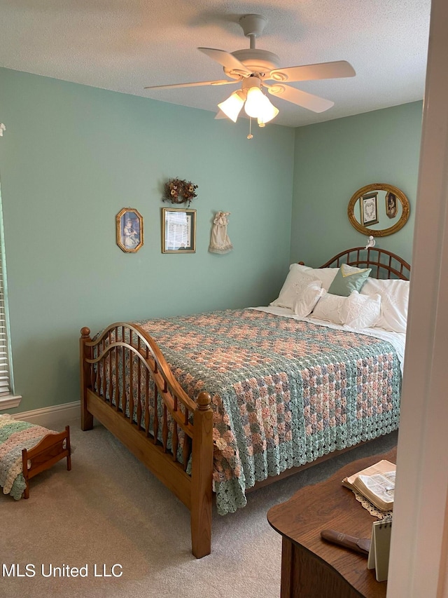 bedroom with carpet flooring, a textured ceiling, and ceiling fan