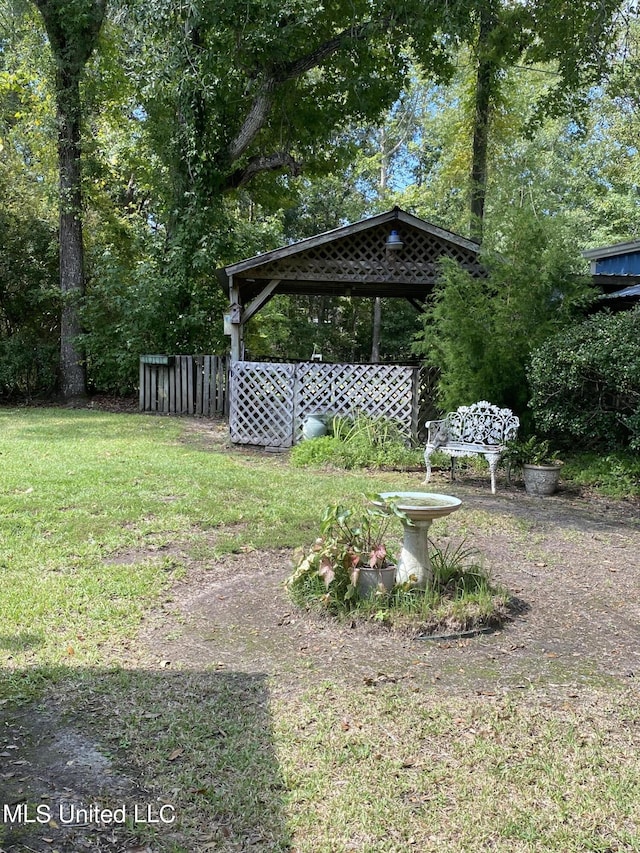 view of yard with fence and a gazebo