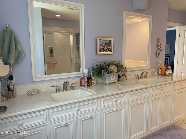 bathroom featuring vanity and an enclosed shower