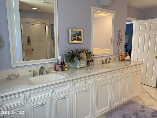 bathroom with vanity, tile patterned floors, and an enclosed shower