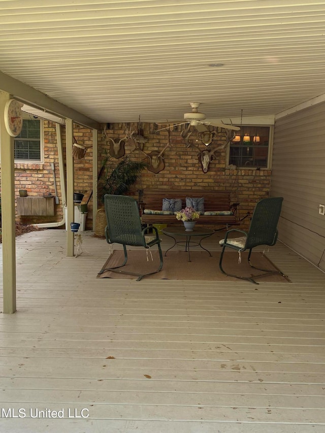 wooden deck featuring ceiling fan