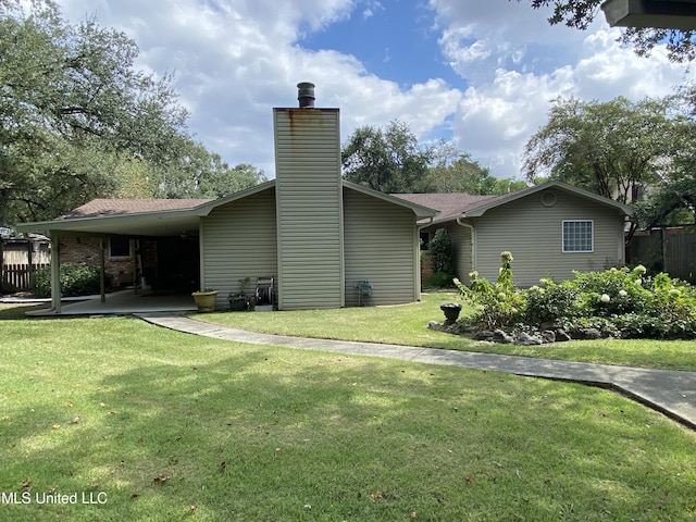 exterior space featuring a yard, a chimney, and fence