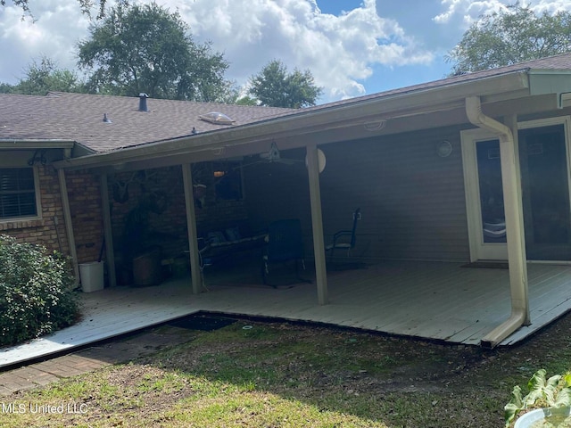 rear view of property featuring a deck