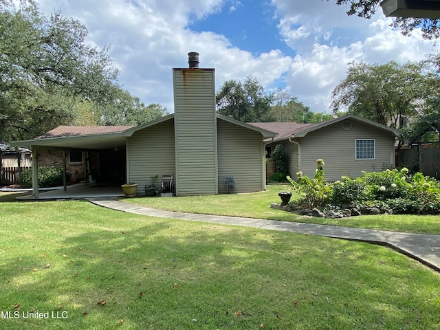 exterior space with a yard and a carport