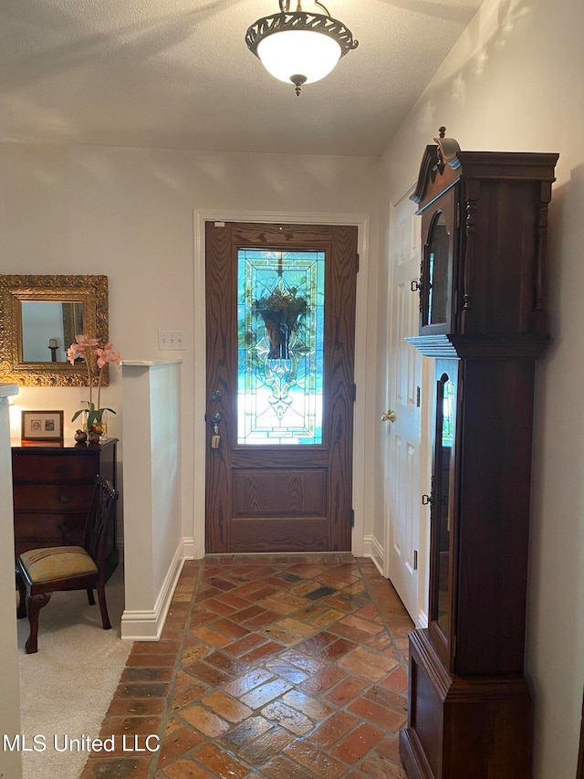 entryway with a textured ceiling