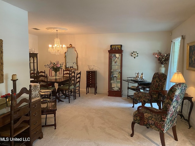 carpeted dining area featuring a chandelier