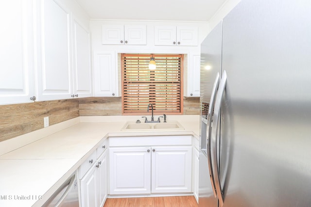 206 Oak Park Dr, Pearl, MS 39208 - kitchen with stainless steel refrigerator with ice dispenser, white cabinets, and light countertops