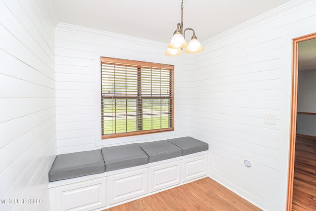 206 Oak Park Dr, Pearl, MS 39208 - unfurnished dining area with a chandelier, crown molding, light wood finished floors, and wooden walls