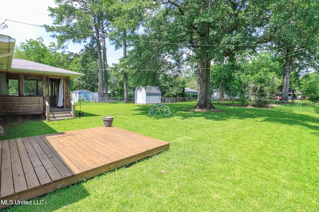 206 Oak Park Dr, Pearl, MS 39208 - fenced backyard featuring a storage shed, a sunroom, and a deck