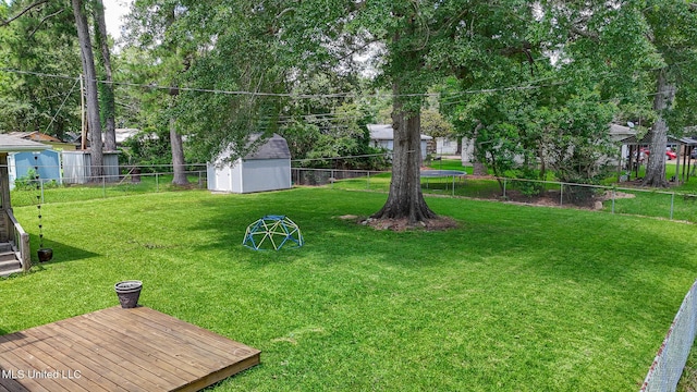 206 Oak Park Dr, Pearl, MS 39208 - fenced backyard with a storage unit and a trampoline