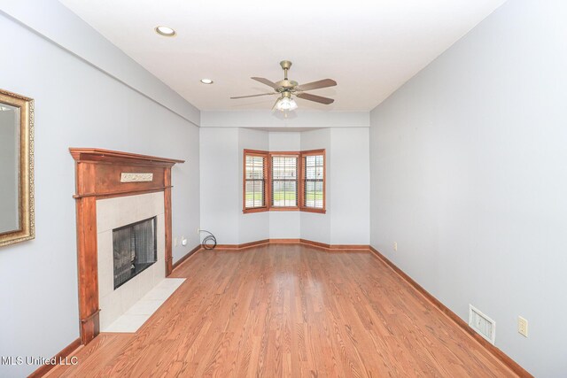 206 Oak Park Dr, Pearl, MS 39208 - unfurnished living room with a fireplace, ceiling fan, light wood finished floors, and recessed lighting