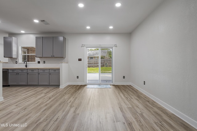 8839 Moanalua Way, Diamondhead, MS 39525 - kitchen featuring gray cabinetry, backsplash, light wood-style flooring, dishwasher, and recessed lighting