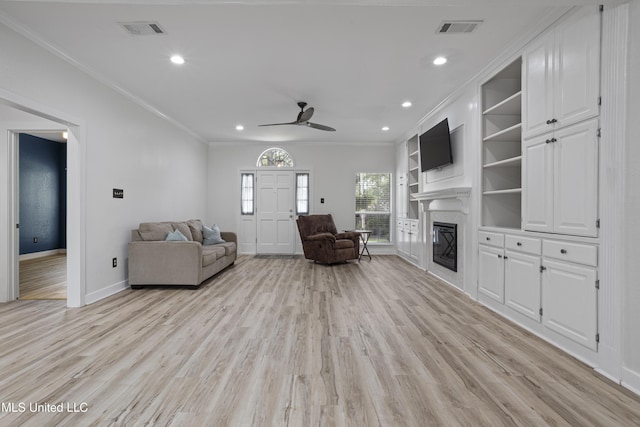 8839 Moanalua Way, Diamondhead, MS 39525 - living room with a glass covered fireplace, crown molding, a ceiling fan, light wood finished floors, and recessed lighting