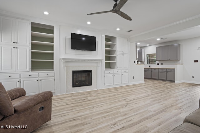 8839 Moanalua Way, Diamondhead, MS 39525 - living room featuring a ceiling fan, ornamental molding, light wood-type flooring, recessed lighting, and built in shelves