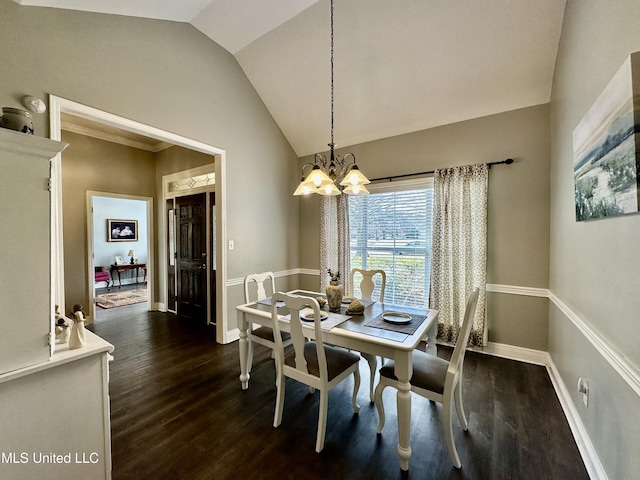 dining area featuring an inviting chandelier, dark hardwood / wood-style floors, and vaulted ceiling