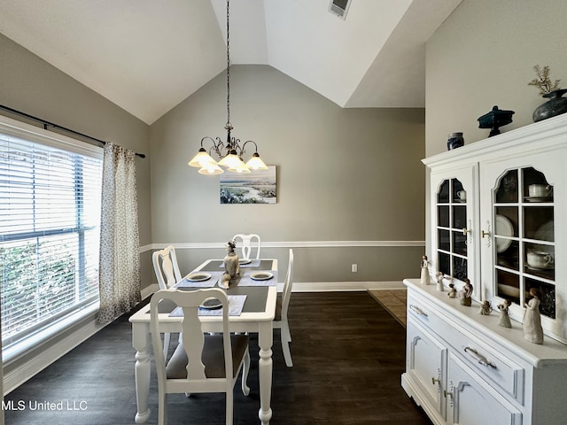 dining space featuring lofted ceiling, dark hardwood / wood-style flooring, and a notable chandelier