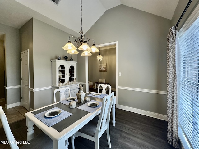 dining space featuring lofted ceiling, dark hardwood / wood-style floors, and a chandelier