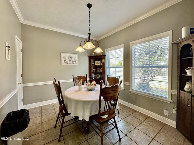 tiled dining space featuring ornamental molding and a chandelier