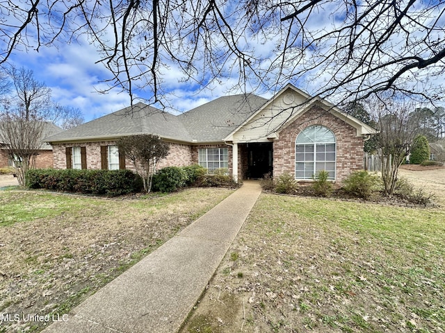 ranch-style home with a front yard