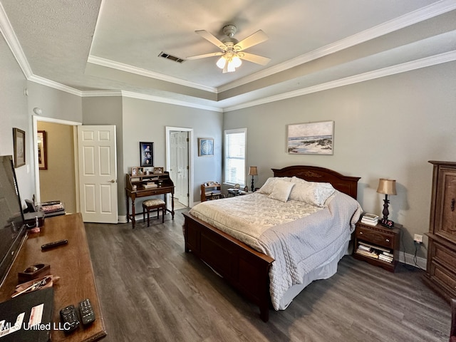 bedroom featuring crown molding, dark hardwood / wood-style floors, a raised ceiling, and ceiling fan