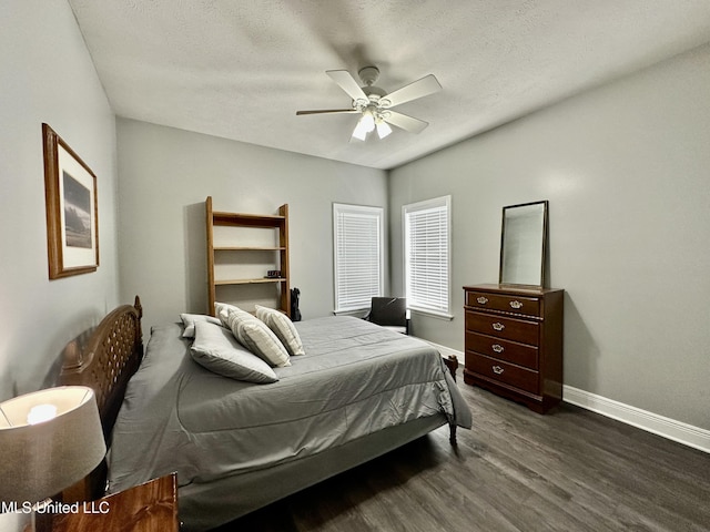 bedroom featuring ceiling fan, dark hardwood / wood-style floors, and a textured ceiling