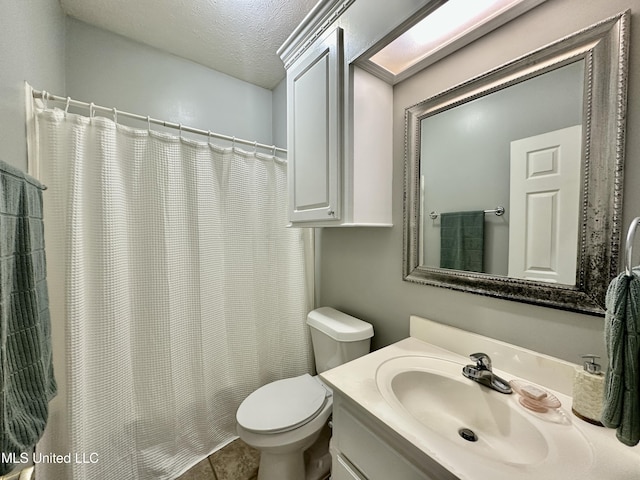 bathroom featuring vanity, a textured ceiling, and a shower with shower curtain