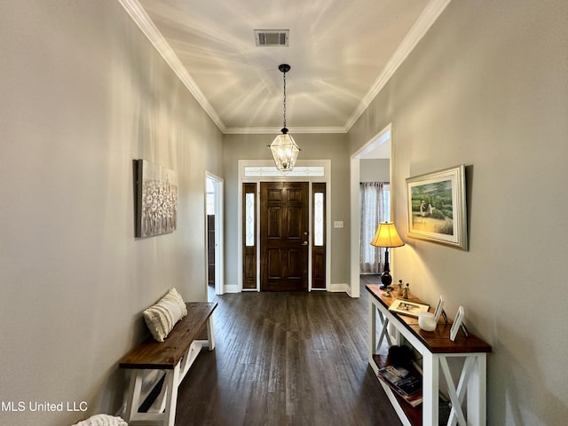 foyer entrance with dark wood-type flooring and ornamental molding