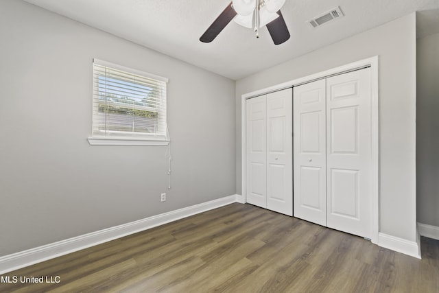 2607 Calle De Feliz St, Gautier, MS 39553 - unfurnished bedroom featuring wood finished floors, a closet, and ceiling fan