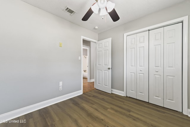 2607 Calle De Feliz St, Gautier, MS 39553 - unfurnished bedroom with dark wood-type flooring, a closet, and ceiling fan