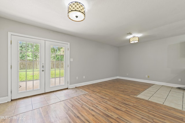 2607 Calle De Feliz St, Gautier, MS 39553 - spare room featuring french doors and wood finished floors
