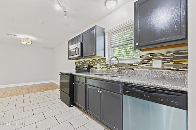 2607 Calle De Feliz St, Gautier, MS 39553 - kitchen featuring stainless steel appliances, tasteful backsplash, rail lighting, and light tile patterned floors