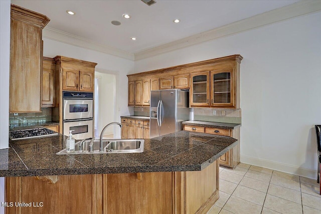 kitchen featuring sink, crown molding, stainless steel appliances, tasteful backsplash, and kitchen peninsula