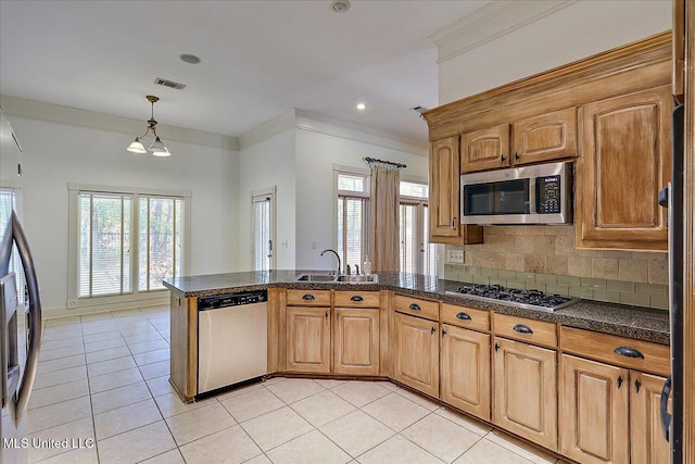 kitchen with sink, light tile patterned floors, appliances with stainless steel finishes, backsplash, and ornamental molding