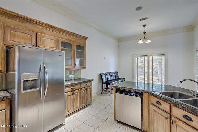 kitchen featuring light tile patterned flooring, sink, crown molding, appliances with stainless steel finishes, and backsplash