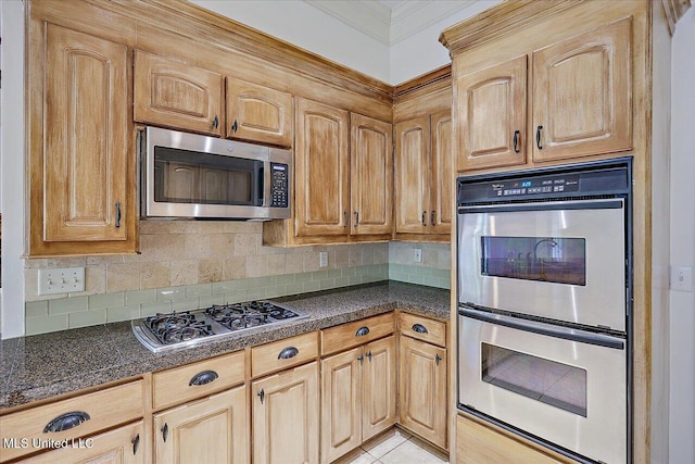 kitchen featuring crown molding, stainless steel appliances, light tile patterned floors, and backsplash