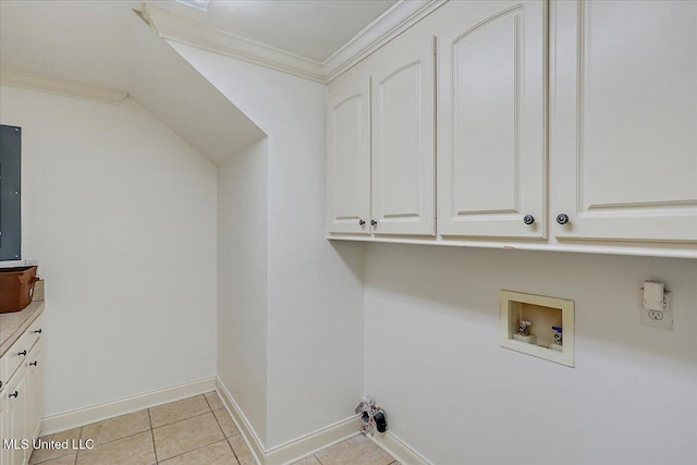 washroom with cabinets, ornamental molding, washer hookup, and light tile patterned floors