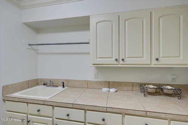 kitchen featuring tile countertops and sink