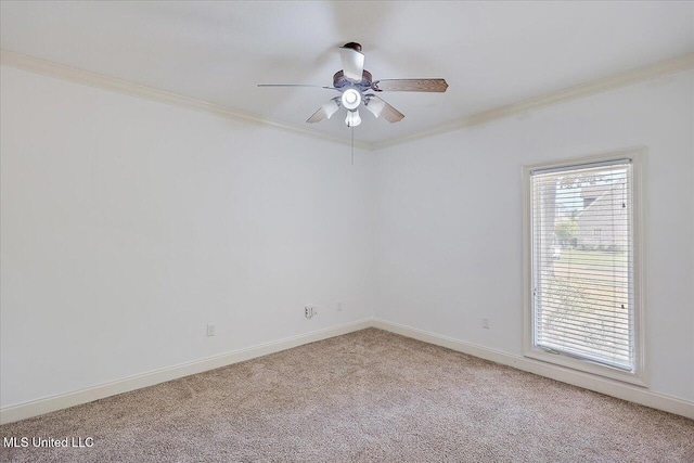 spare room featuring ornamental molding, light colored carpet, and ceiling fan