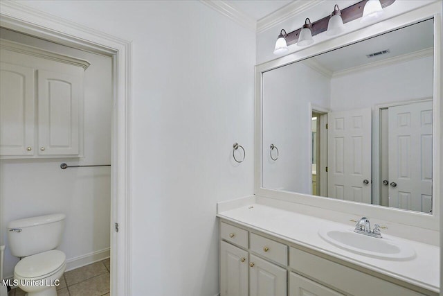 bathroom with crown molding, vanity, tile patterned floors, and toilet