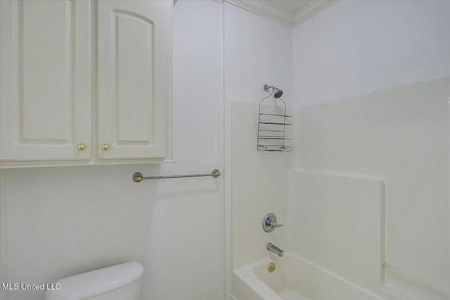 bathroom featuring bathtub / shower combination, toilet, and crown molding