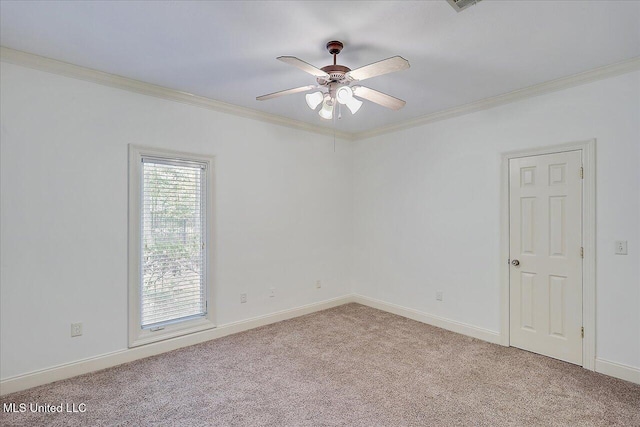 spare room with ceiling fan, light colored carpet, and ornamental molding