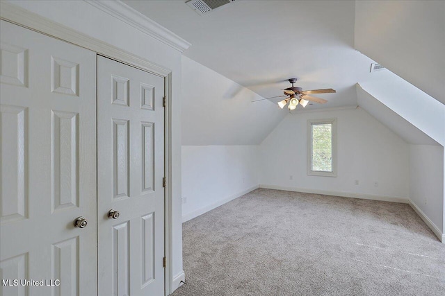 bonus room with vaulted ceiling, light carpet, and ceiling fan