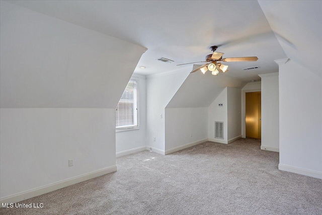 bonus room with vaulted ceiling, light colored carpet, and ceiling fan