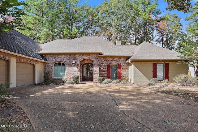 view of front of house with a garage and french doors